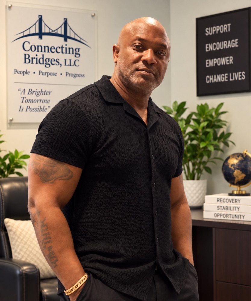 Jesse Hinton, Certified Peer Support Specialist at Connecting Bridges, standing in the office
